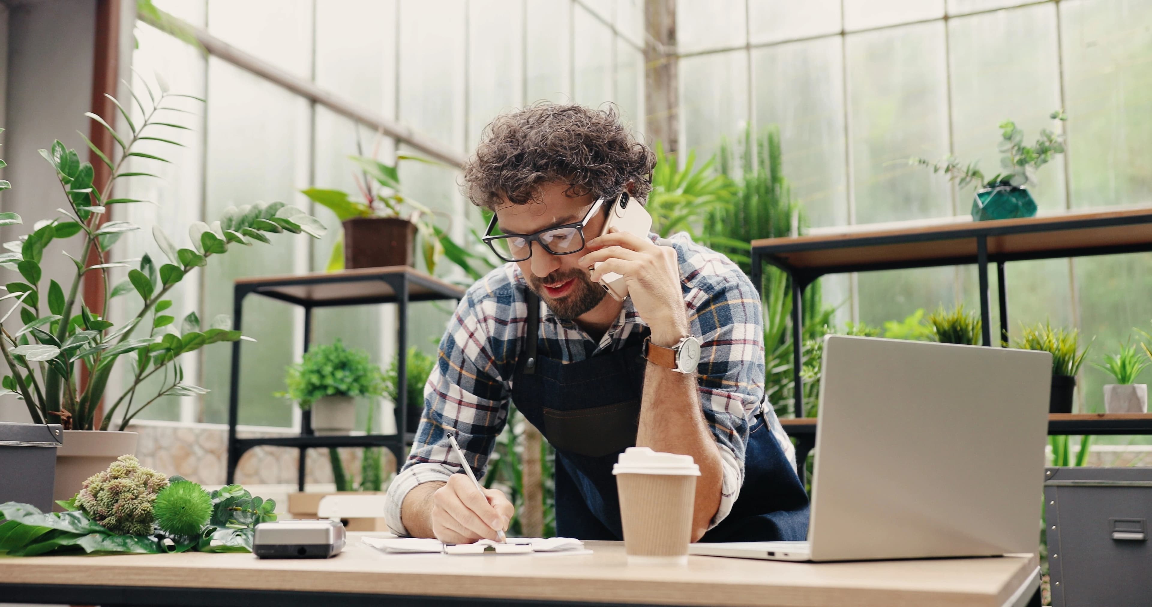 Person making a phone call for and taking notes